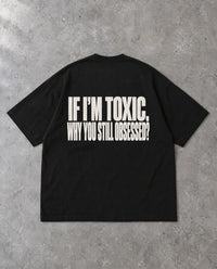 STILL OBSESSED — Oversized Tee in Black, Rückenprint, Flat-Lay