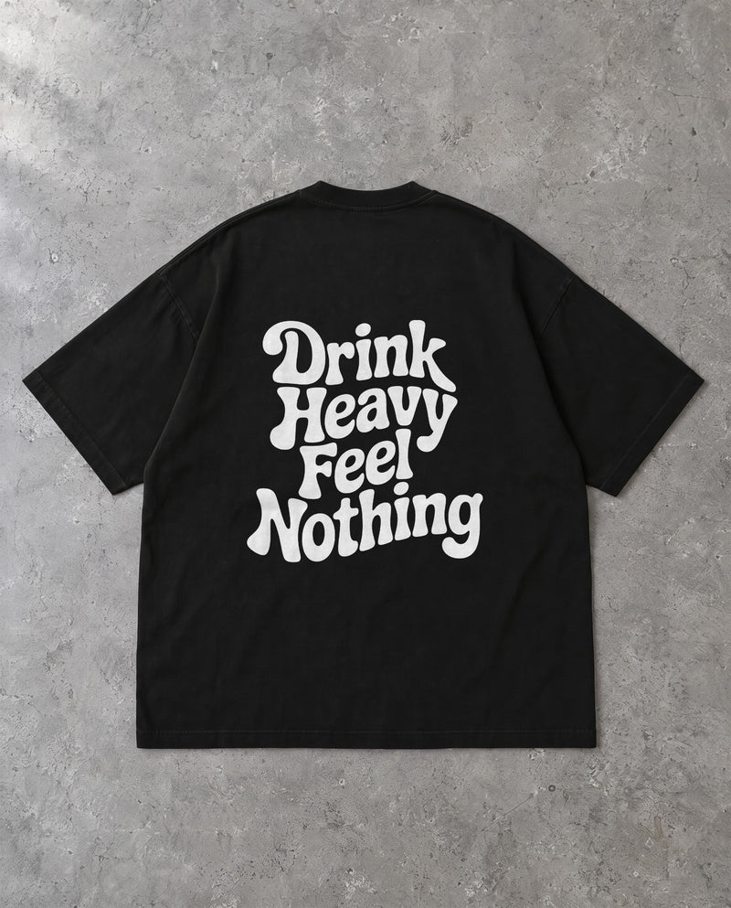 DRINK HEAVY — Oversized Tee in Black, Rückenprint, Flat-Lay