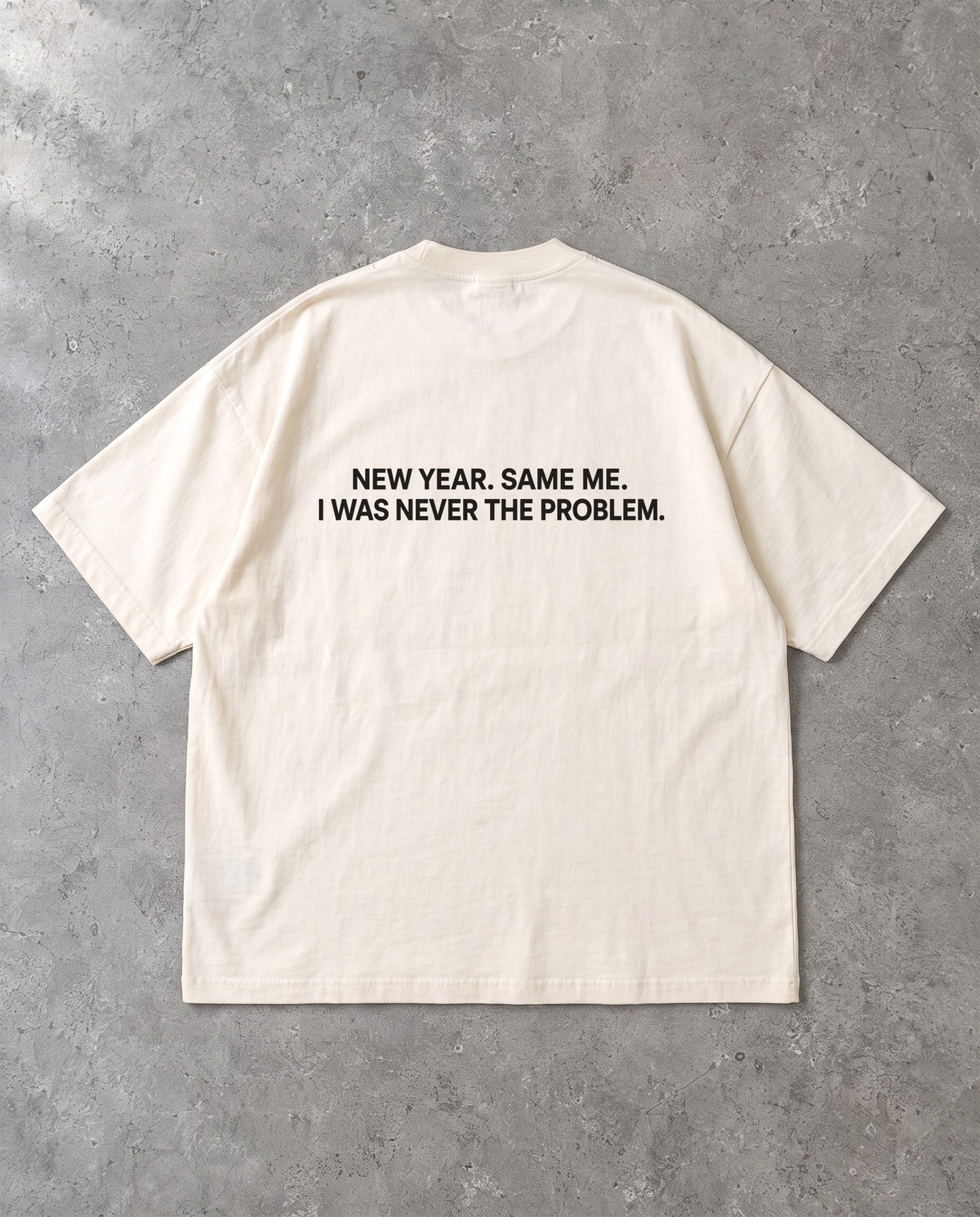 NEVER THE PROBLEM — Oversized Tee in Natural Raw, Rückenprint, Flat-Lay